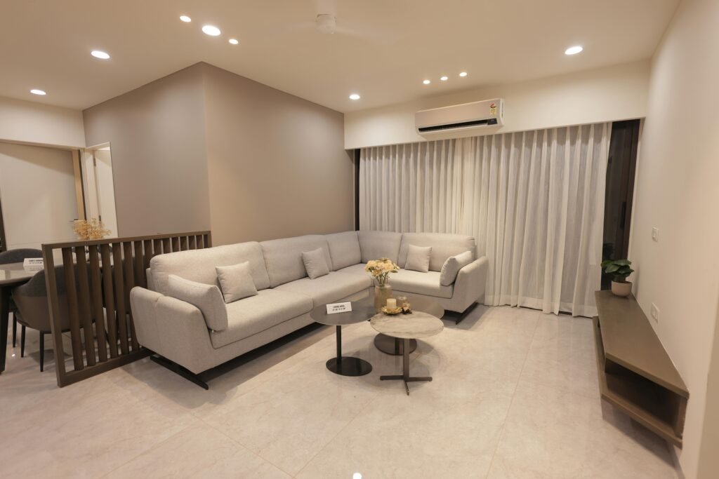 Spacious living room with gray sofa, coffee table, and ambient lighting in a modern minimalist design.