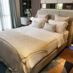 Cozy and elegant modern bedroom interior with neutral tones and stylish decor.